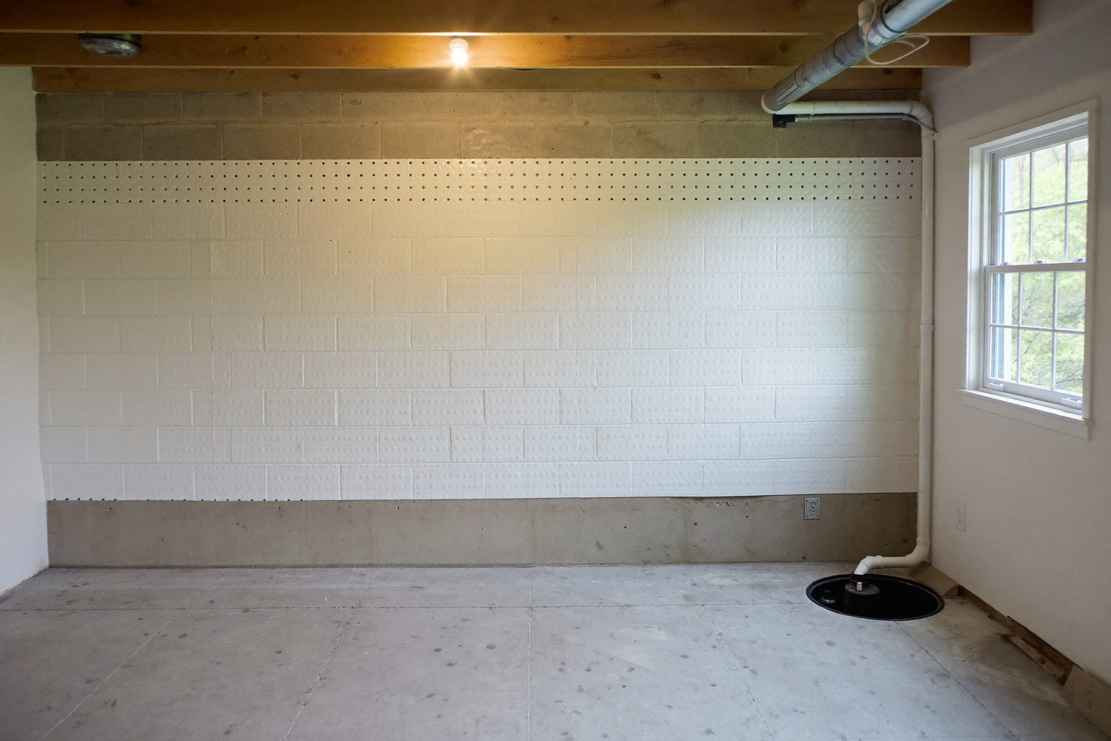 Interior basement waterproofing with drainage membrane and sump pump in Arlington VA